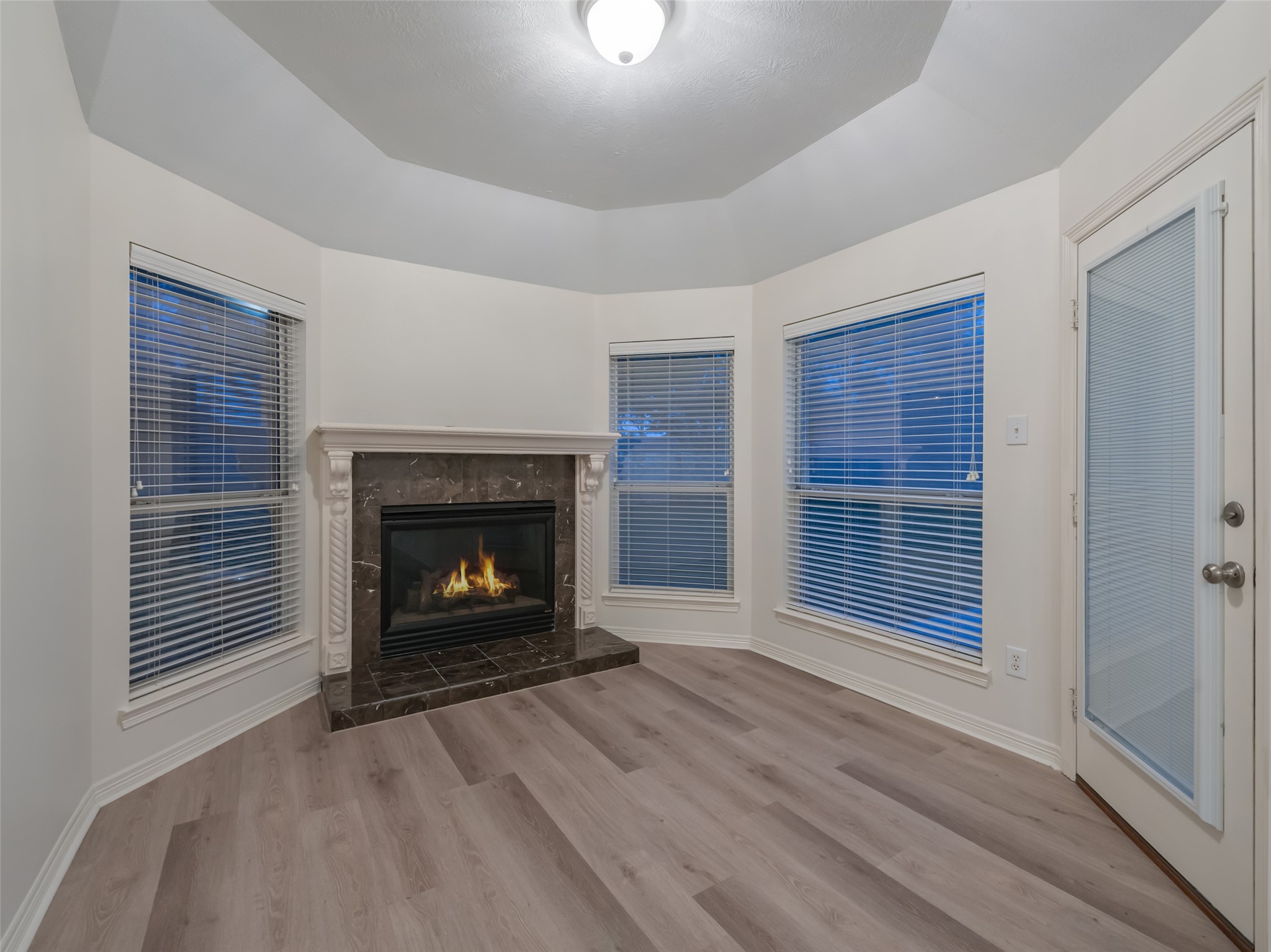 1511 Baldridge Lane Katy, TX 77494 - Photo 27 of 50 a view of an empty room with wooden floor fireplace and a window