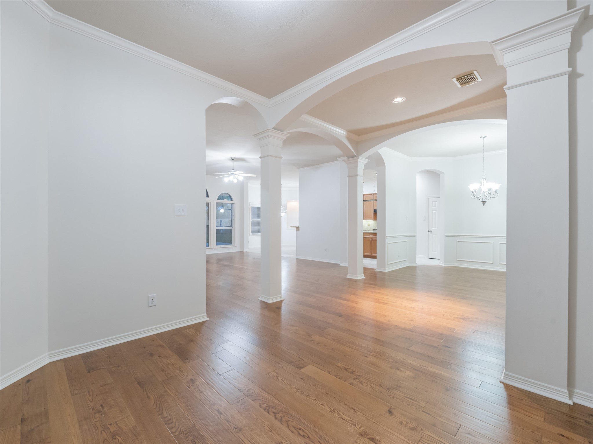 1511 Baldridge Lane Katy, TX 77494 - Photo 7 of 50 a view of an empty room with wooden floor and a bathroom