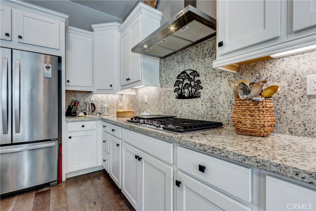11137 Briar Rose Court Corona, CA 92883 - Photo 21 of 75 a kitchen with stainless steel appliances granite countertop a stove and a refrigerator