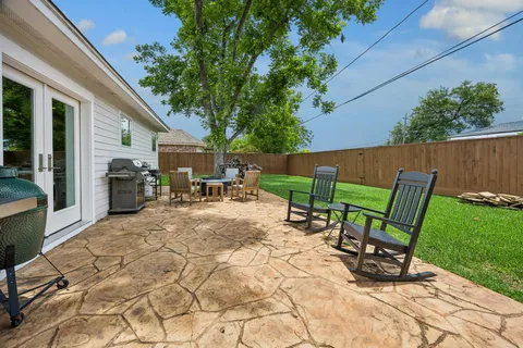 a view of backyard with outdoor seating a patio and plants