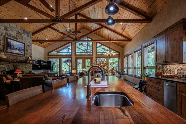 a kitchen with furniture wooden floor and a sink