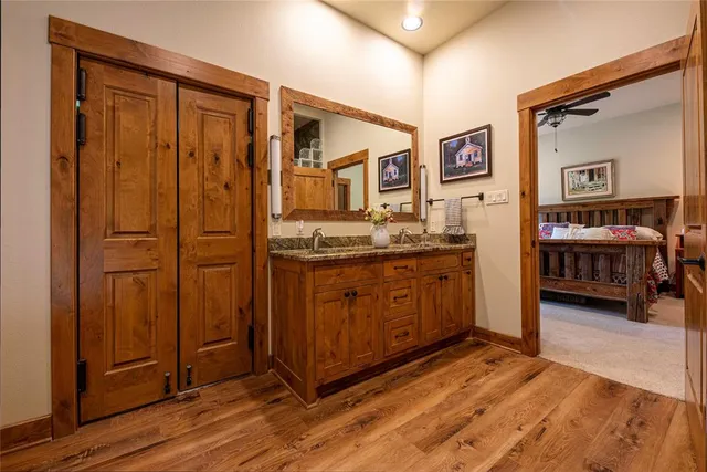 a view of a bedroom with furniture and wooden floor