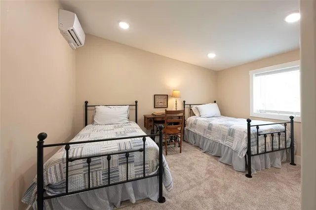 a bedroom with a bed a table and painting