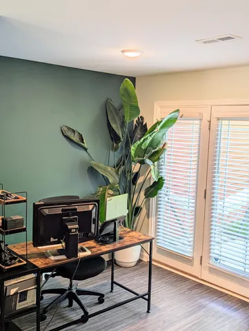 a view of a workspace with furniture and a potted plant