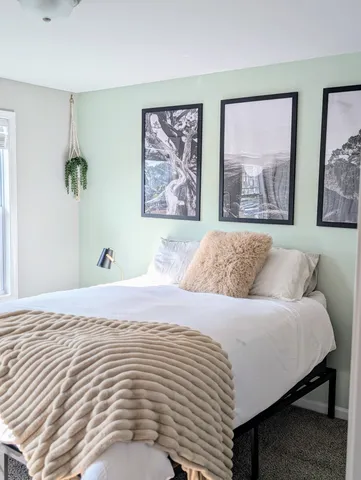 a bedroom with a bed and wall painting