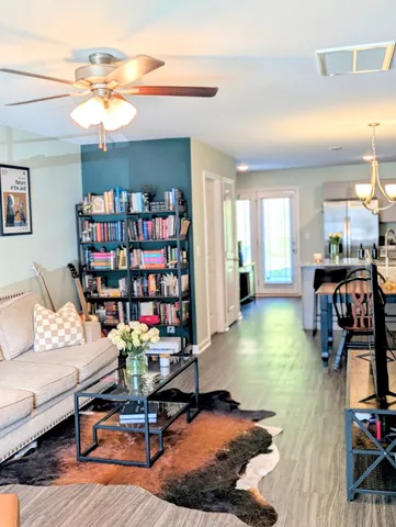 a living room with furniture a view and bookshelf