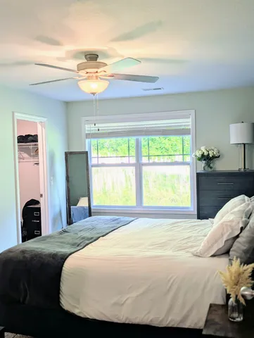 a bedroom with a bed and a window