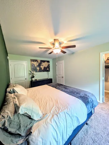 a bedroom with a bed and a mirror