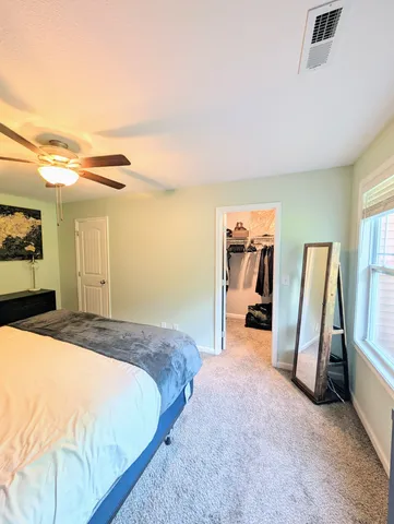 a spacious bedroom with a bed and a couch