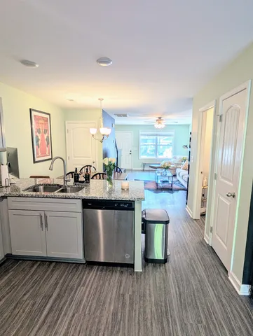 a kitchen with lots of counter top space and wooden floor