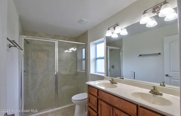 a bathroom with a sink toilet a mirror and shower