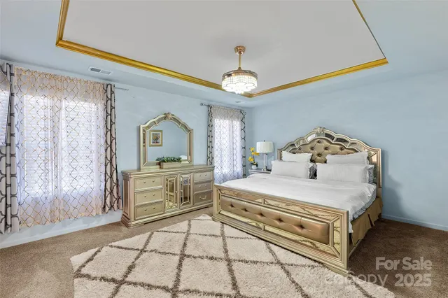a bedroom with a bed and a chandelier