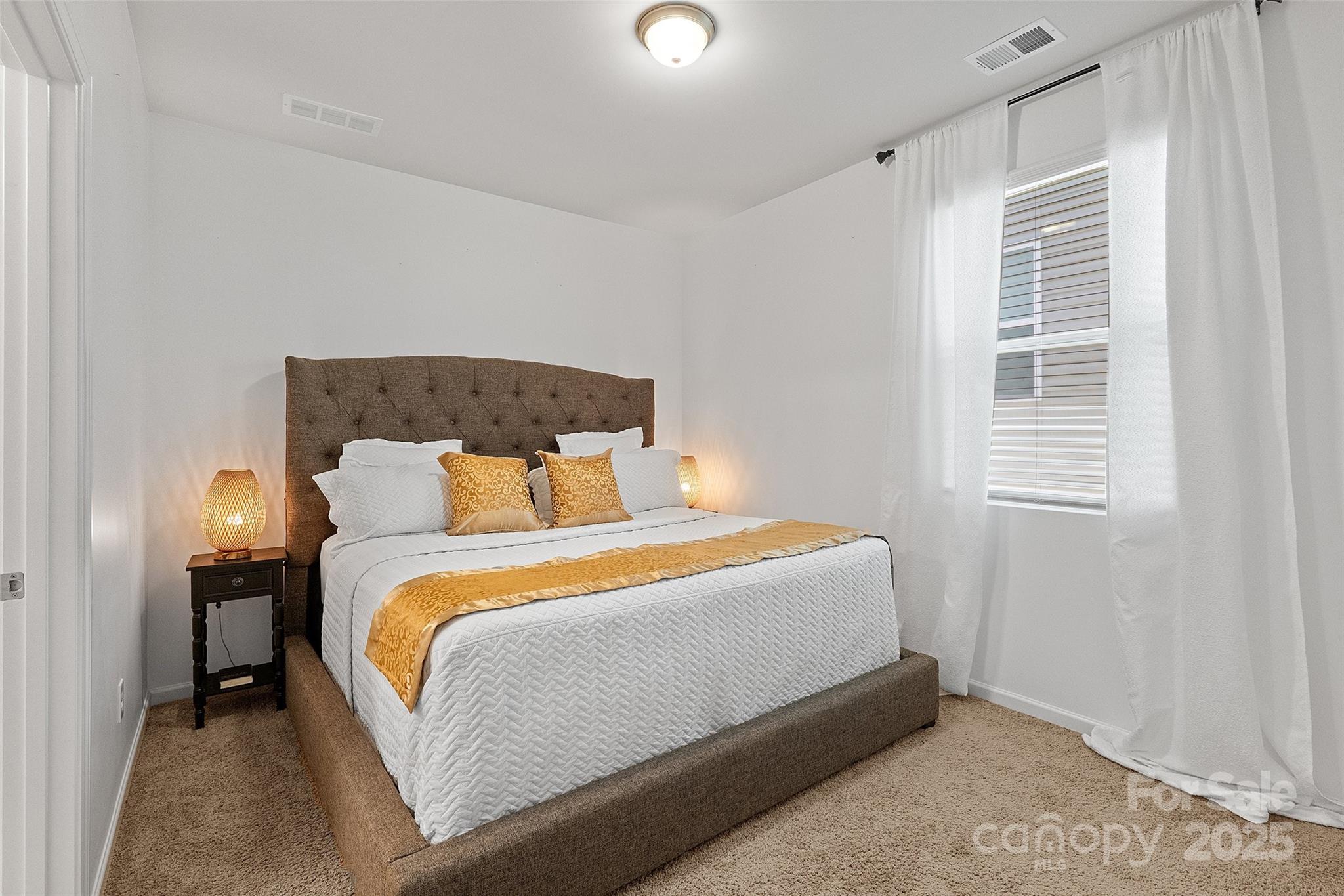 14027 Ridgewater Way Charlotte, NC 28278 - Photo 25 of 48 a bed sitting in a bedroom next to a window