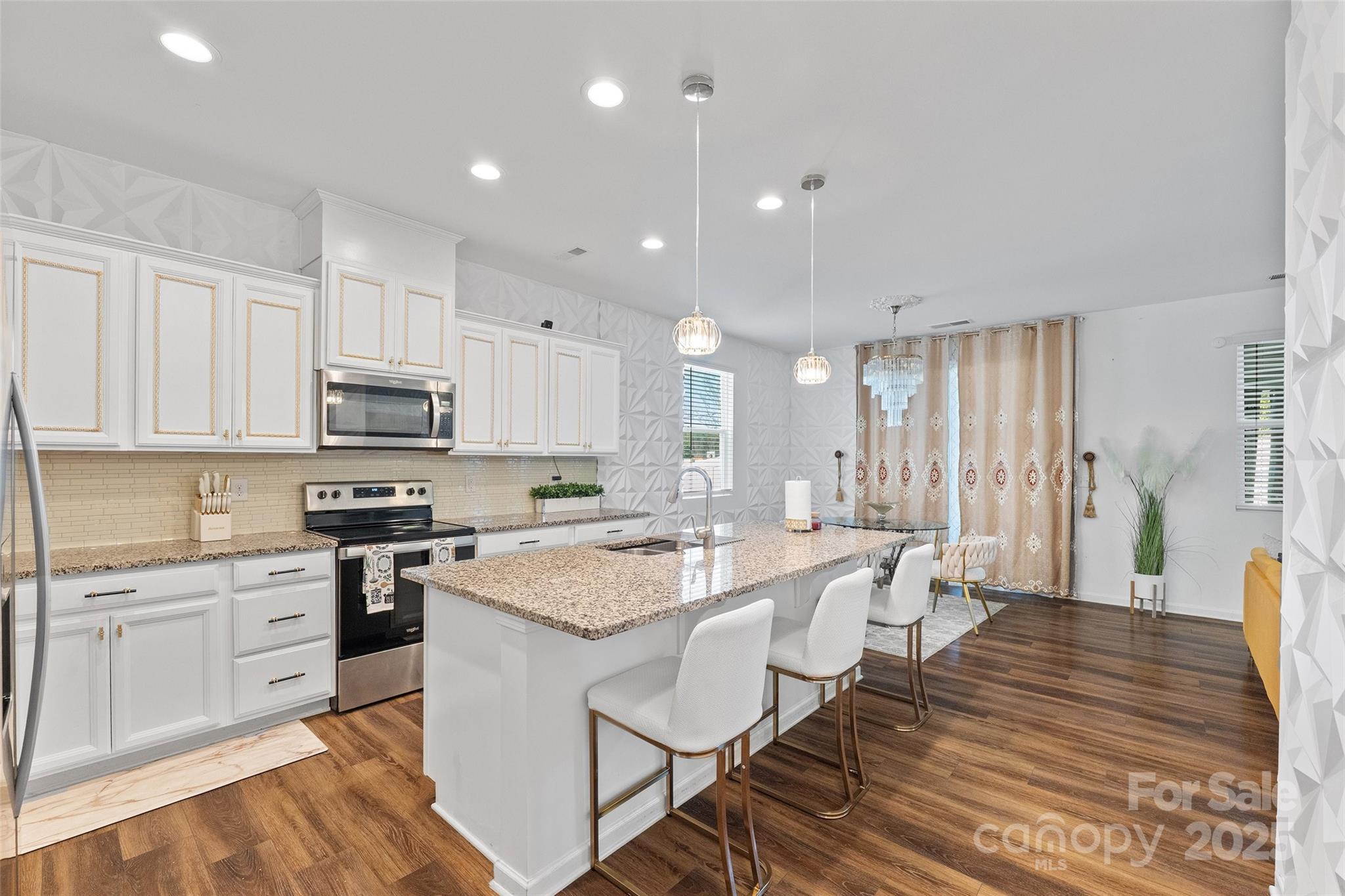 14027 Ridgewater Way Charlotte, NC 28278 - Photo 31 of 48 a large kitchen with stainless steel appliances granite countertop a table chairs sink and cabinets