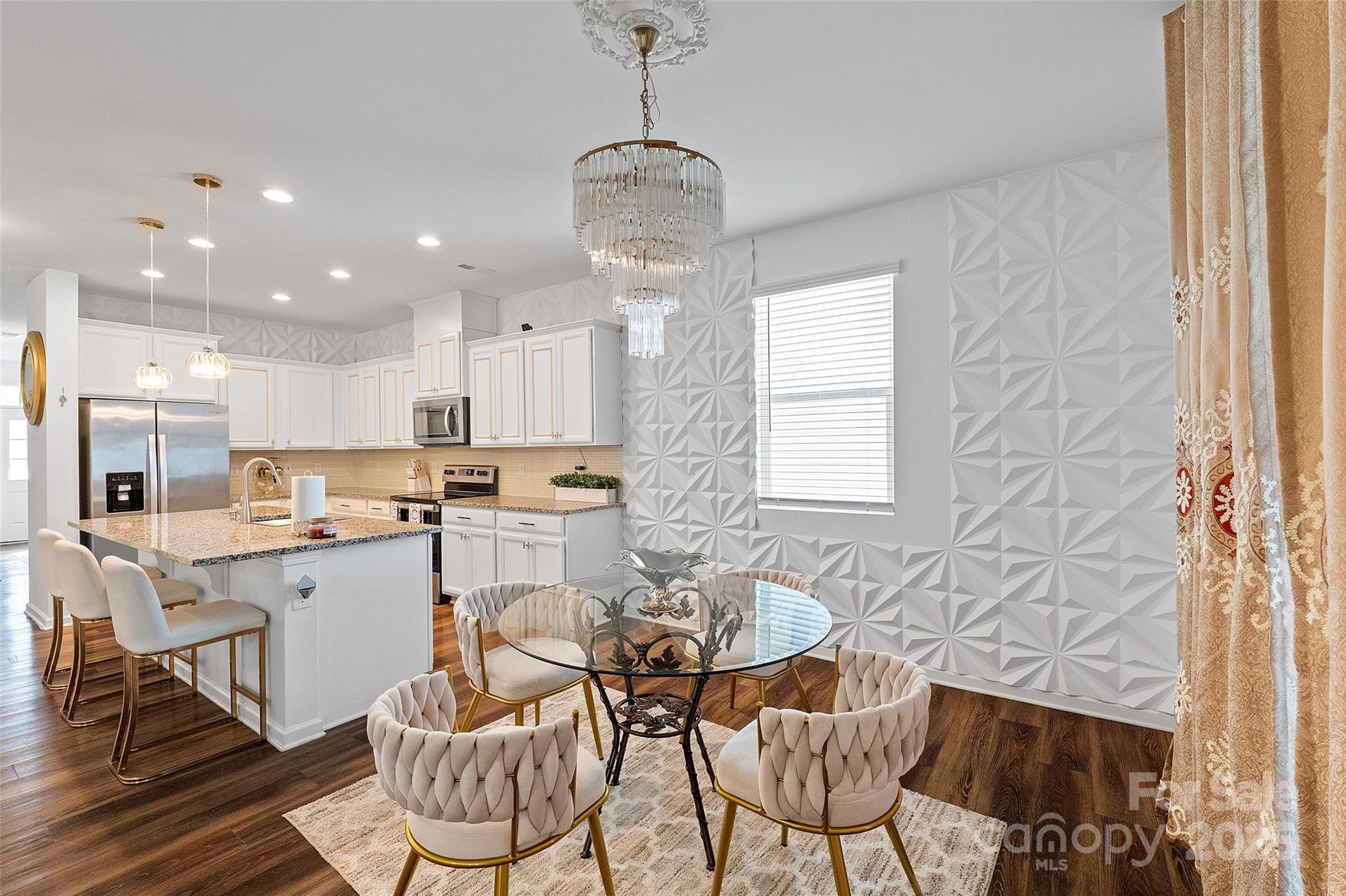 14027 Ridgewater Way Charlotte, NC 28278 - Photo 32 of 48 a kitchen with stainless steel appliances granite countertop a stove a sink a dining table and chairs with wooden floor