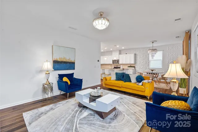 a living room with furniture and a chandelier
