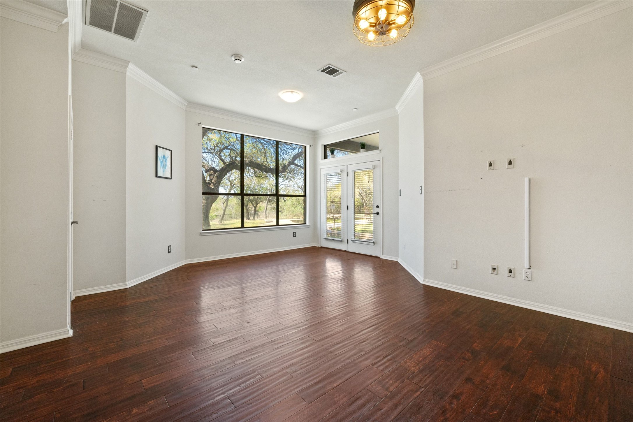 815 Elliott Ranch Road Buda, TX 78610 - Photo 14 of 40 Unfurnished room with dark wood-style floors and ornamental molding