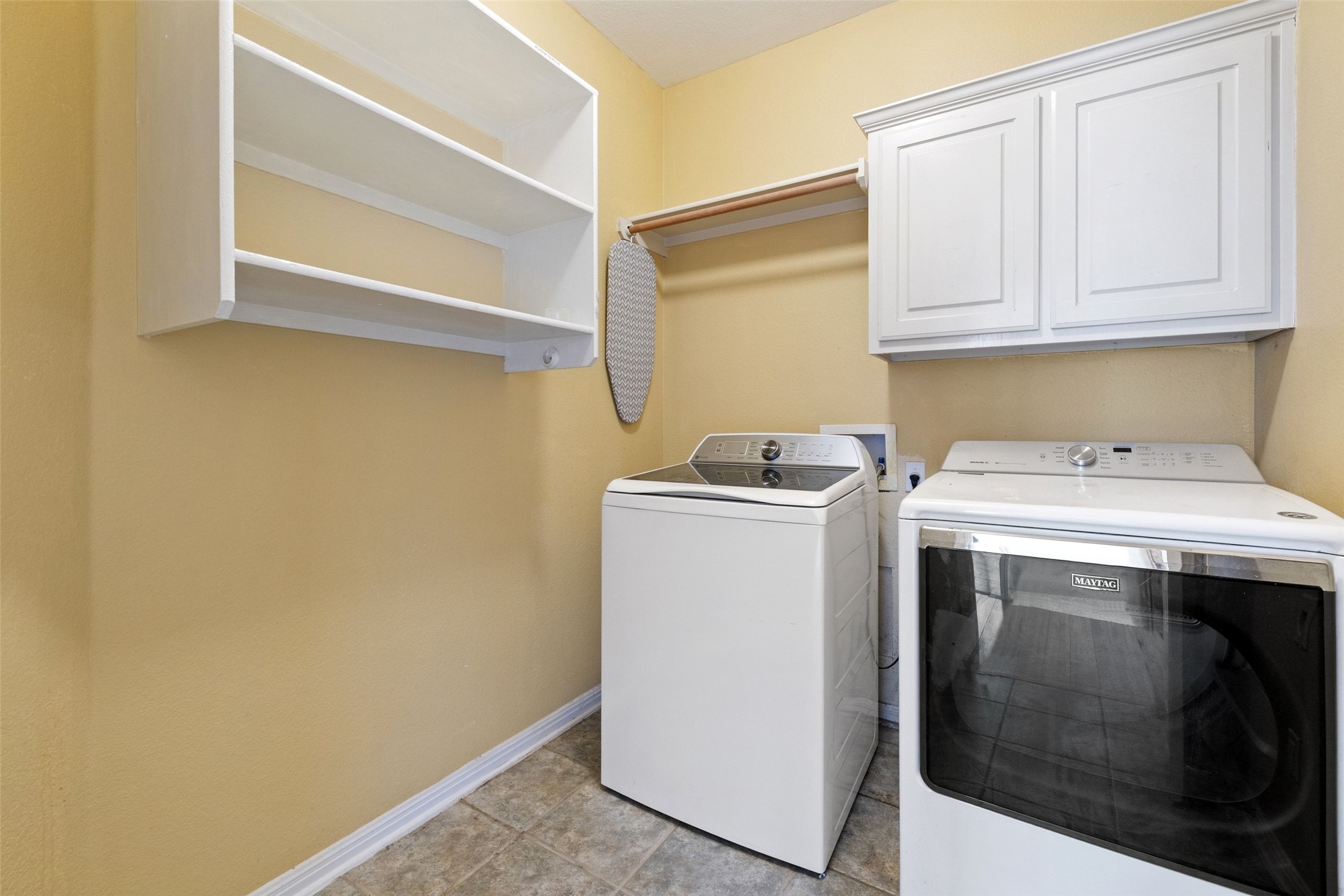 815 Elliott Ranch Road Buda, TX 78610 - Photo 16 of 40 Laundry room with washer and dryer hook ups and cabinet space