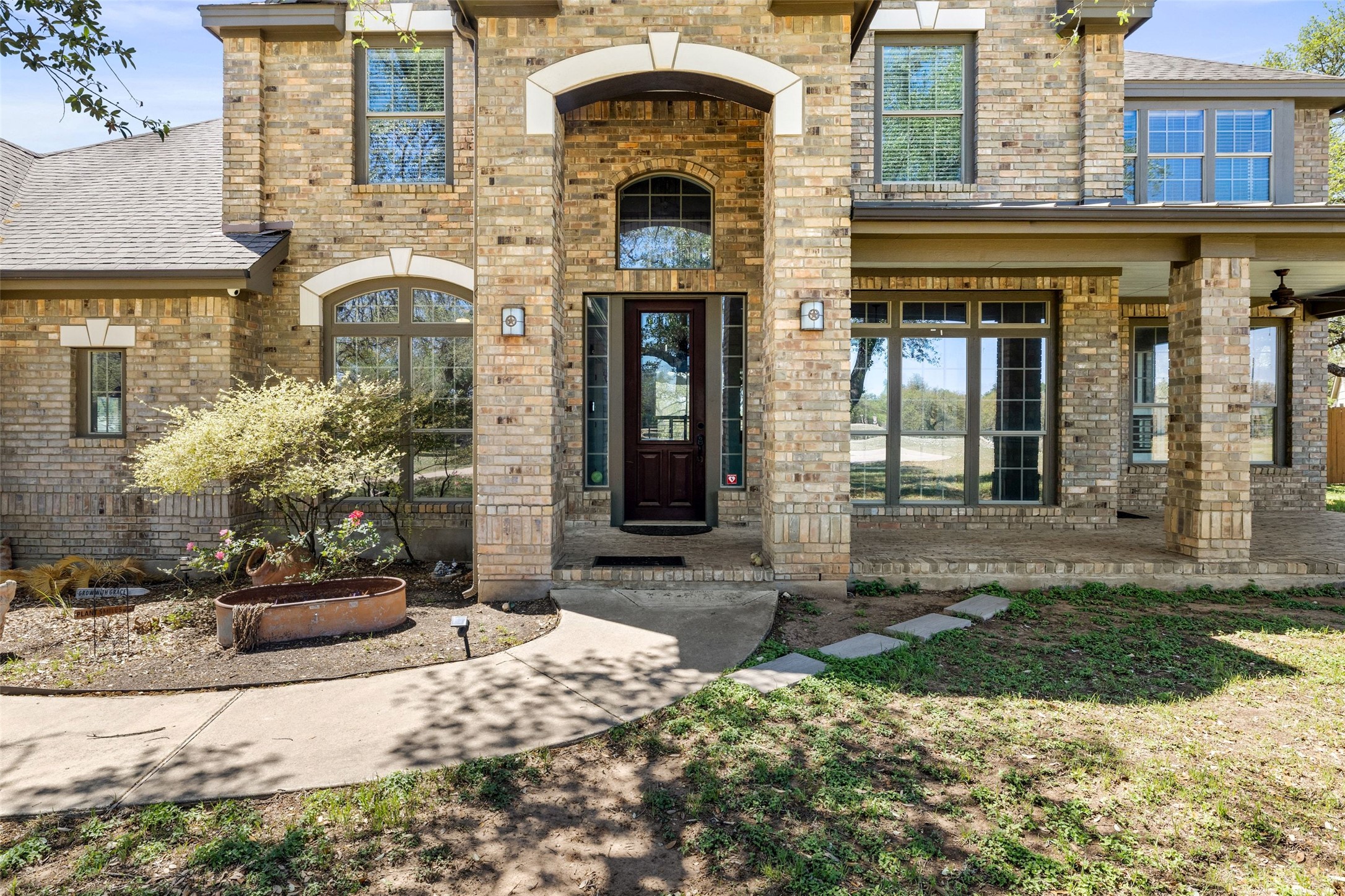 815 Elliott Ranch Road Buda, TX 78610 - Photo 2 of 40 Doorway to property with brick, a porch, and roof with shingles