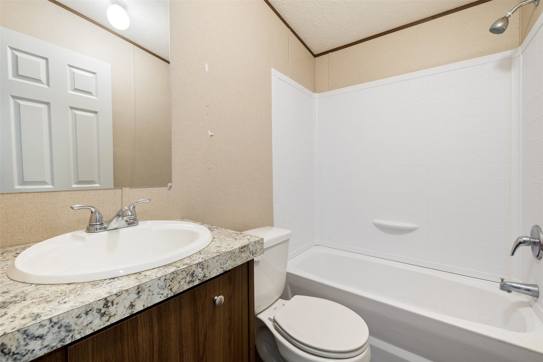 815 Elliott Ranch Road Buda, TX 78610 - Photo 38 of 40 Bathroom in mobile home with vanity, bathtub / shower combination, a textured ceiling, and crown molding