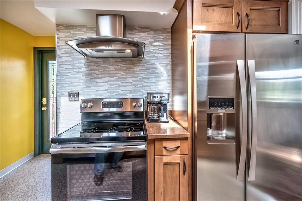 9101 Pannier Road Pittsburgh, PA 15237 - Photo 17 of 24 Eat-in Kitchen beautifully renovated with 2 Skylights, Maple Cabinetry, Under Cabinet Lighting, Corian Countertops, sleek new Flooring, Tile Backsplash, Electric Range, Refrigerator, Dishwasher & Microwave Oven