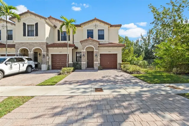a front view of a house with a yard and garage