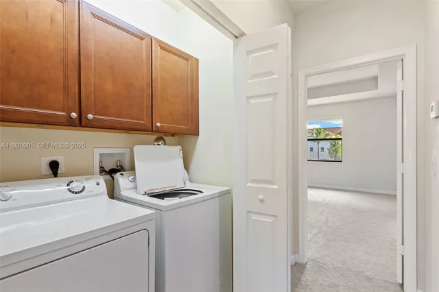a view of storage and utility room with washer and dryer