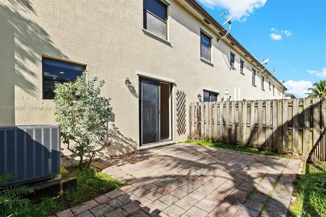 a view of staircase with wooden fence and plants