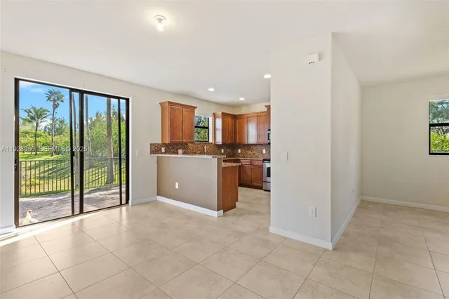 a view of a kitchen with a sink and a large window