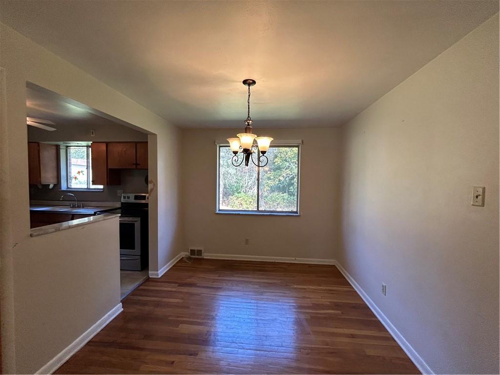 423 Sharon Road Coraopolis, PA 15108 - Photo 5 of 24 a view of an empty room with window and wooden floor
