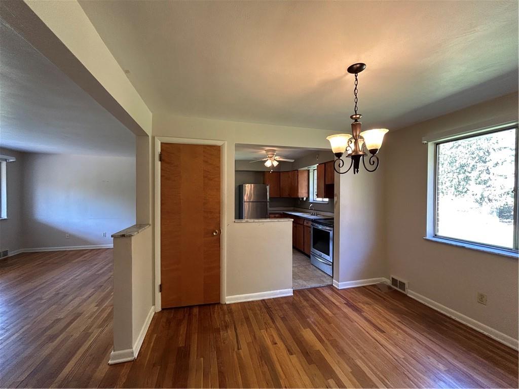 423 Sharon Road Coraopolis, PA 15108 - Photo 6 of 24 a view of a livingroom with wooden floor and a kitchen
