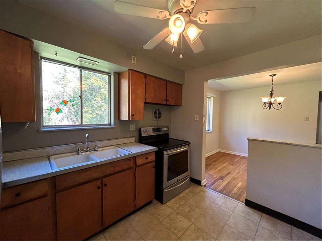 423 Sharon Road Coraopolis, PA 15108 - Photo 8 of 24 a kitchen with a stove sink and cabinets