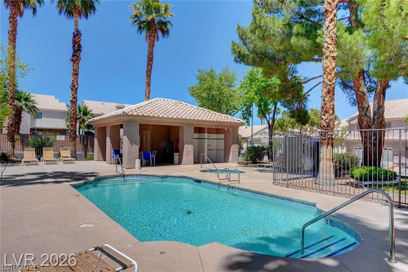 5370 Runningbrook Road Las Vegas, NV 89120 - Photo 25 of 30 An inviting community pool with a spa, clubhouse, and lush landscaping offers a serene escape.