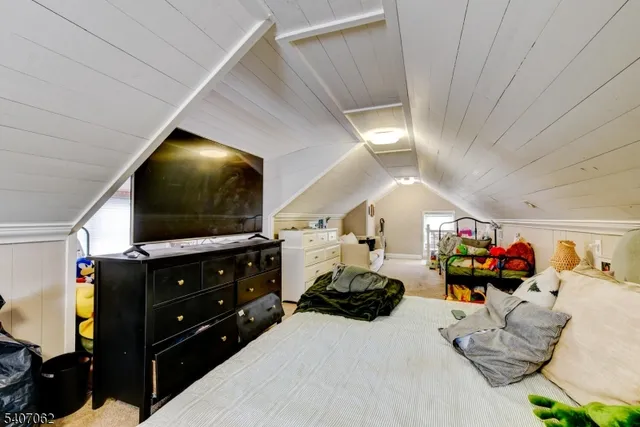 a bedroom with furniture and a flat screen tv