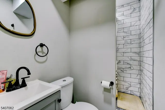 a bathroom with a sink a toilet and mirror