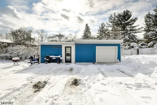 a view of a house with a snow in the background