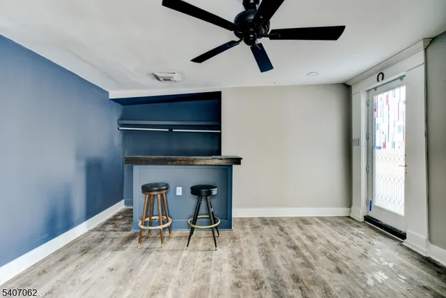 a view of a hallway with wooden floor and workspace