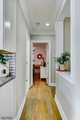 a view of a hallway view with wooden floor and furniture