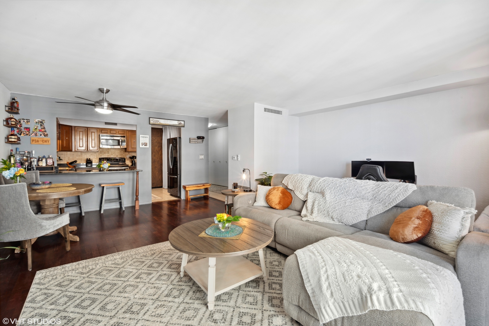 6007 North Sheridan Road, Unit 31F Chicago, IL 60660 - Photo 2 of 43 a living room with furniture and a dining table with kitchen view