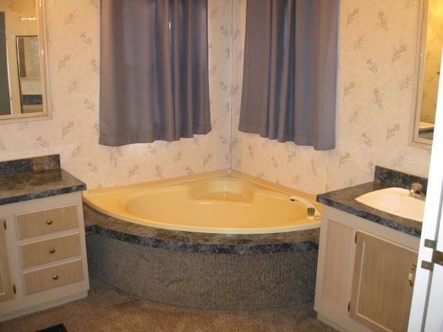1270 Magic Sands Way Turlock, CA 95380 - Photo 14 of 25 a bathroom with a granite countertop sink and a bathtub