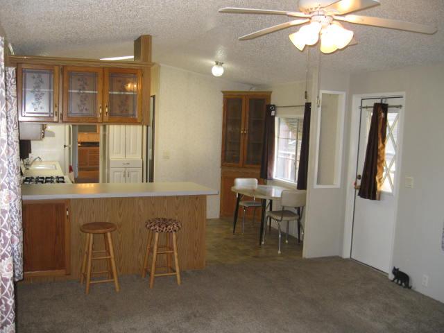 1270 Magic Sands Way Turlock, CA 95380 - Photo 5 of 25 a view of a dining room with furniture and chandelier fan