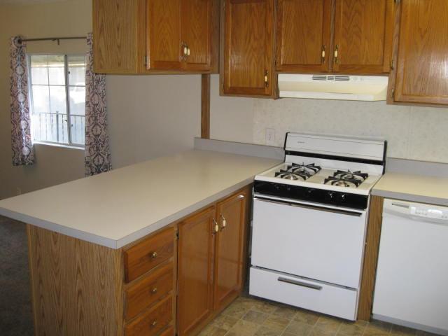 1270 Magic Sands Way Turlock, CA 95380 - Photo 7 of 25 a kitchen with cabinets appliances and wooden cabinets