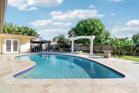 a view of a house with swimming pool and sitting area