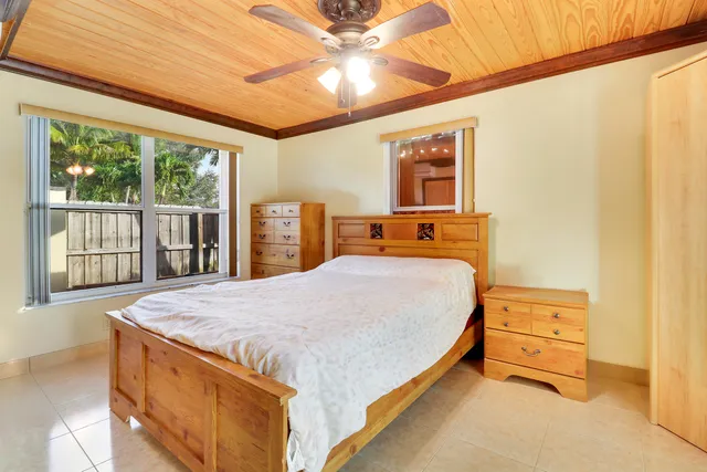 a bathroom with a granite countertop sink toilet and mirror