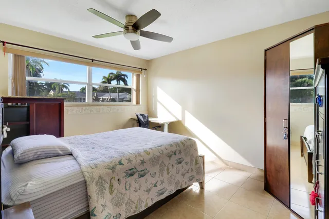 a large living room with stainless steel appliances furniture a fireplace and a flat screen tv