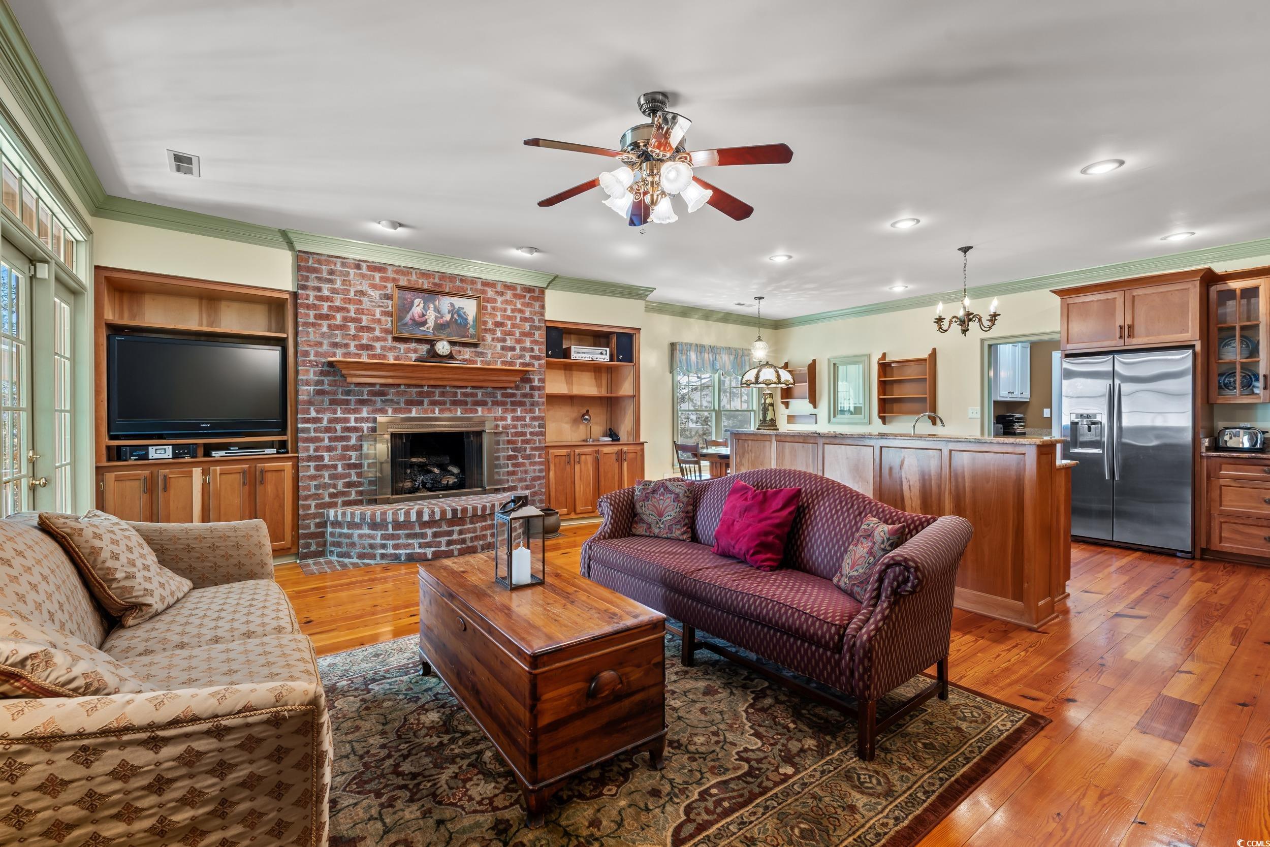246 County Rd S-22-656 Murrells Inlet, SC 29576 - Photo 4 of 39 Living room with heart-pine flooring, fireplace wi