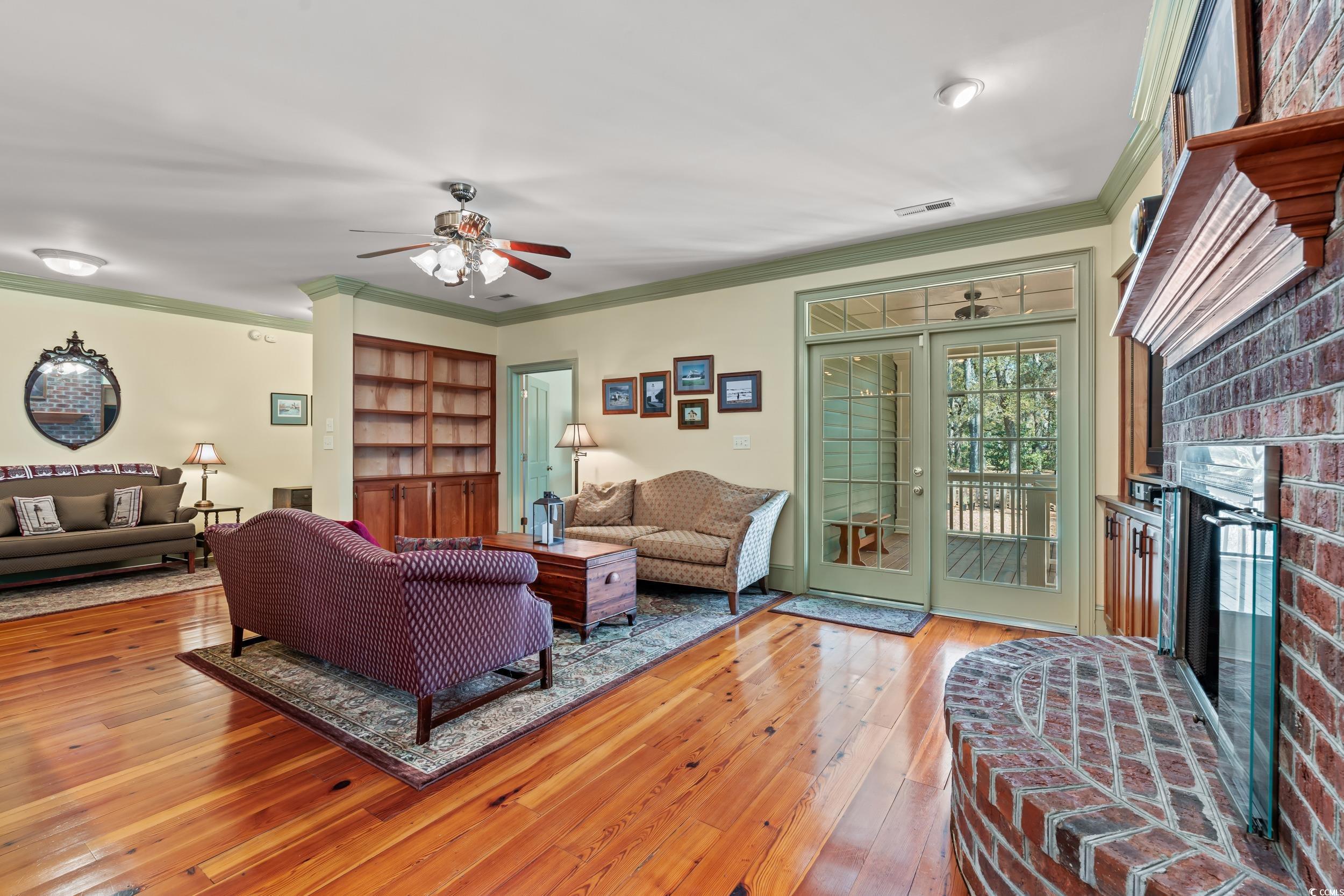 246 County Rd S-22-656 Murrells Inlet, SC 29576 - Photo 5 of 39 Living room with visible vents, crown molding, a b