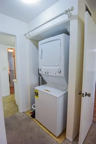 a living room with furniture and floor to ceiling windows