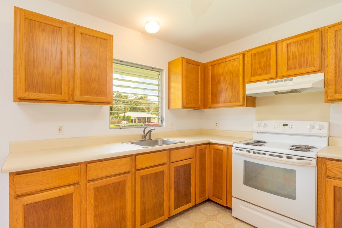 6363 A Puupilo Road Kapaa, HI 96746 - Photo 3 of 19 a kitchen with stainless steel appliances granite countertop white cabinets sink and a microwave