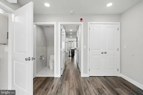 a view of a room with wooden floor and a bathroom